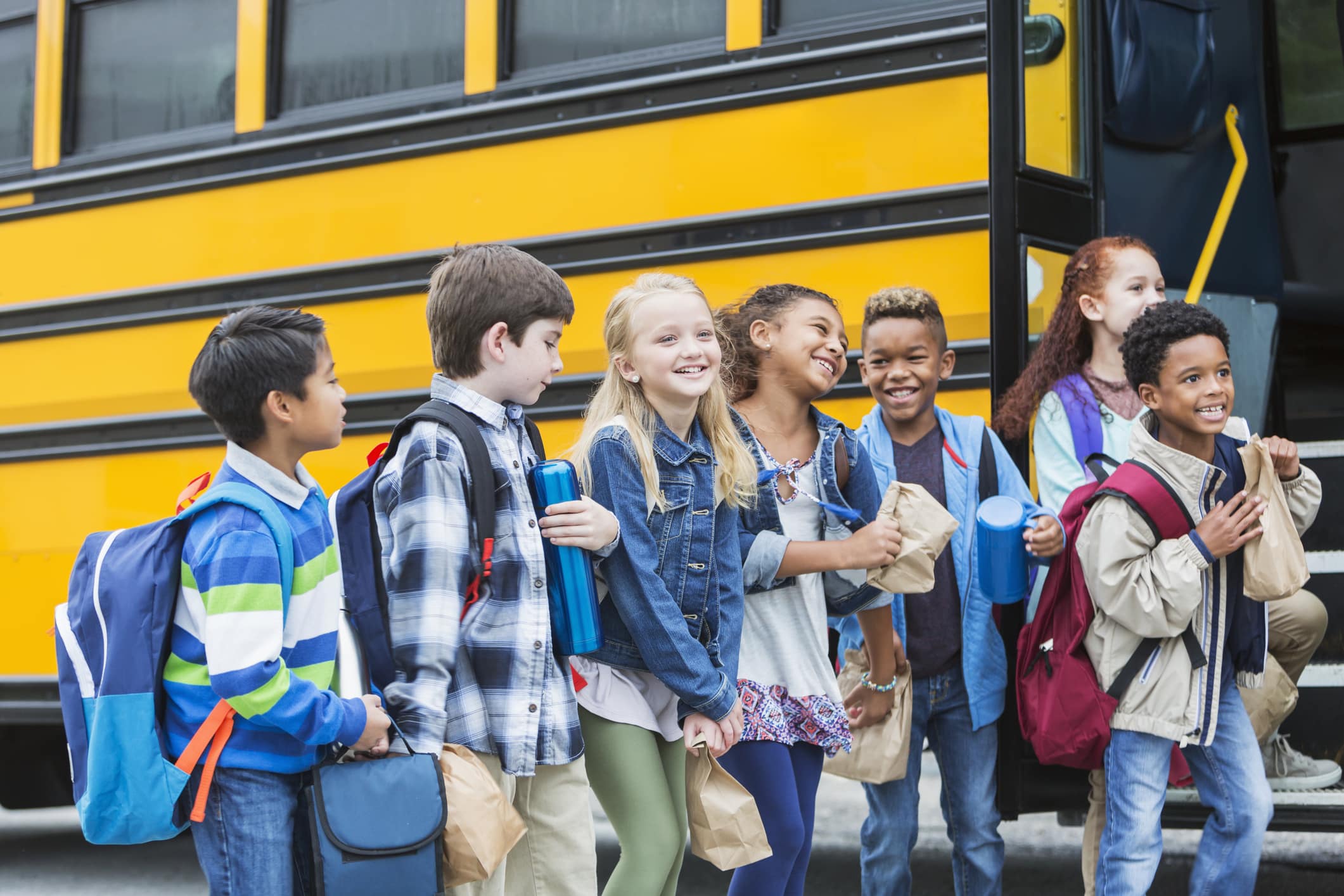 green-room Elementary school children waiting outside bus